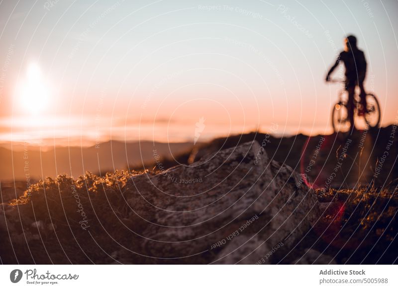 Man riding on bike on hill man helmet extreme sport mountain bicycle top guy sky sun sunshine male safety heaven adventure adrenaline mtb sunlight peak