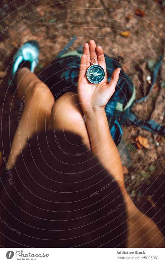 Person sitting and navigating with compass in his hands travel destination navigation location tourism holiday journey direction strategy exploration trip