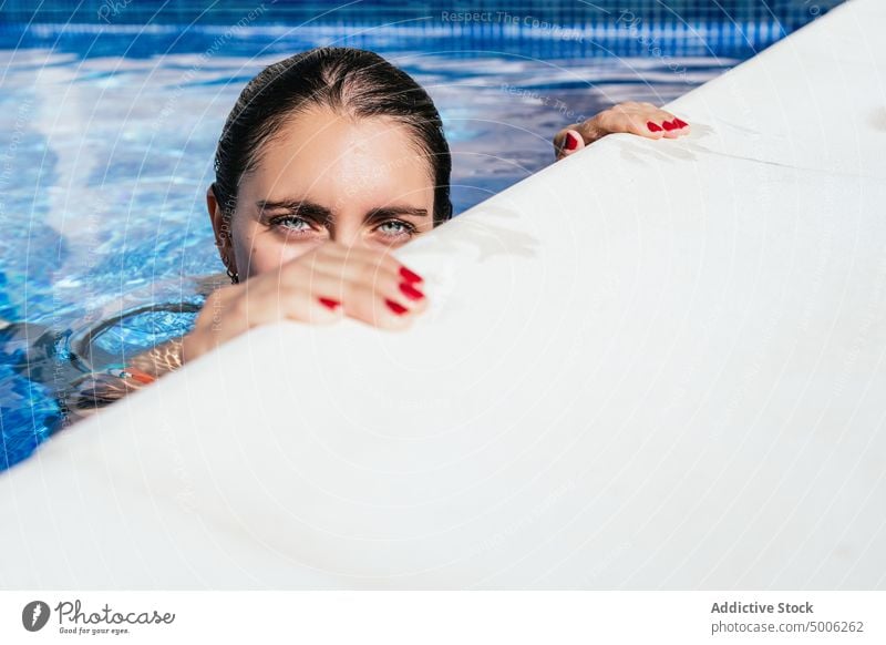 Happy woman chilling in outdoor pool poolside summer enjoy happy swim refreshment water holiday young female vacation resort recreation summertime rest hot