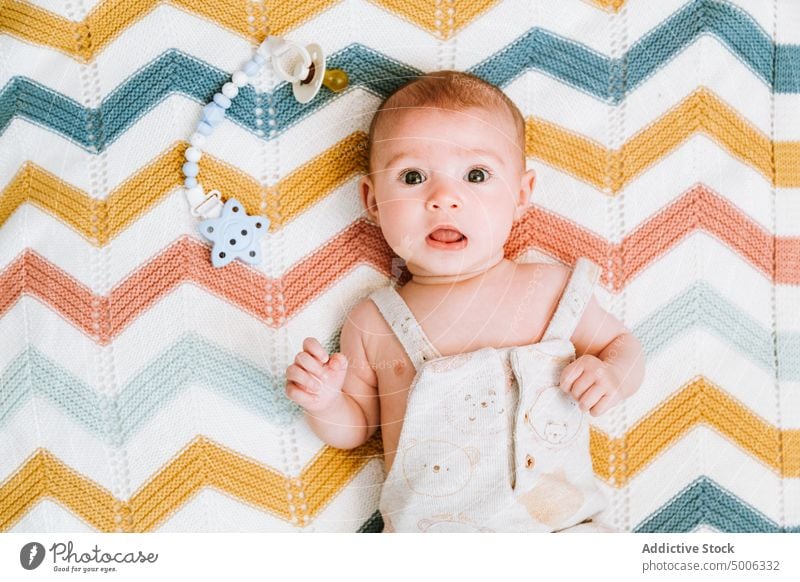 Calm cute baby resting in crib bed relax kid infant calm home child tranquil curious bedroom interest innocent babyhood plaid serene charming carefree shirtless