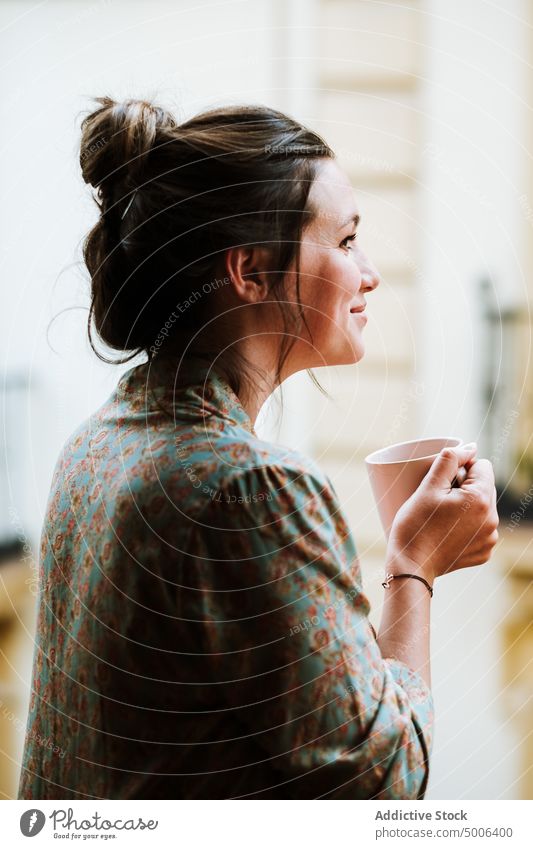 Young woman with cup of tasty coffee chilling at home drink mug comfort happy relax refreshment female break lounge aromatic beverage liquid cozy hot office tea