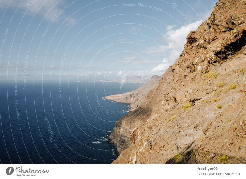 Volcanic cliff over the sea copy space volcanic rocks canary islands spain ocean black sky nobody trip creek place coast coastline canarian touristic africa