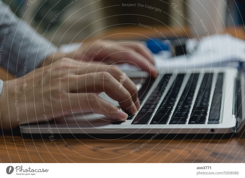 Man using computer laptop working internet searching social media and communications digital technology online at desk. typing person office business keyboard