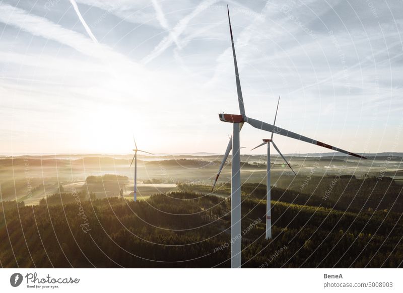 Wind turbine in the sunrise seen from an aerial view Aerial Clean Cleantech Converter Country Countryside Electrical Electricity Energy Forest Future Generation