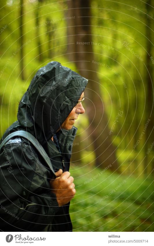 Hiking in the rain hikers Senior citizen Man Rain Forest Rain jacket Rain wear Rainy weather Hooded (clothing) Wet nature-lover Nature Bad weather Human being