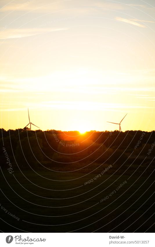 Wind turbines at sunset Wind energy plant Sunset sunshine Sunbeam Energy Renewable energy wind power Pinwheel stream Power Generation Wind power station