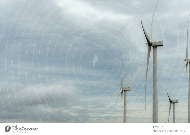 Wind energy. Wind power. Sustainable, renewable energy. Wind turbines generate electricity. Windmill against blue sky and sun light. Green technology. Renewable resource. Sustainable development.