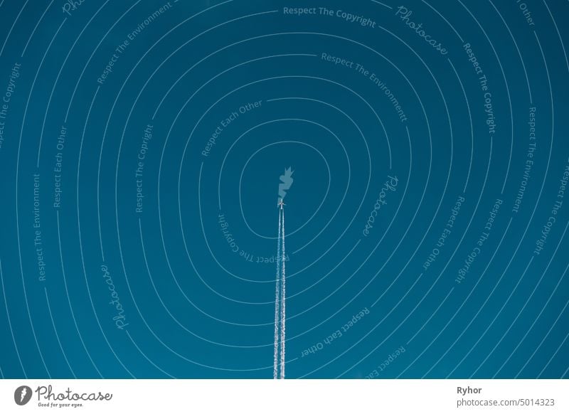 Contrail In Blue Sky. Aircraft Plane In Clear Sunny Sky Background white atmosphere journey clear speed background sky pollution flight blue airplane fly bright