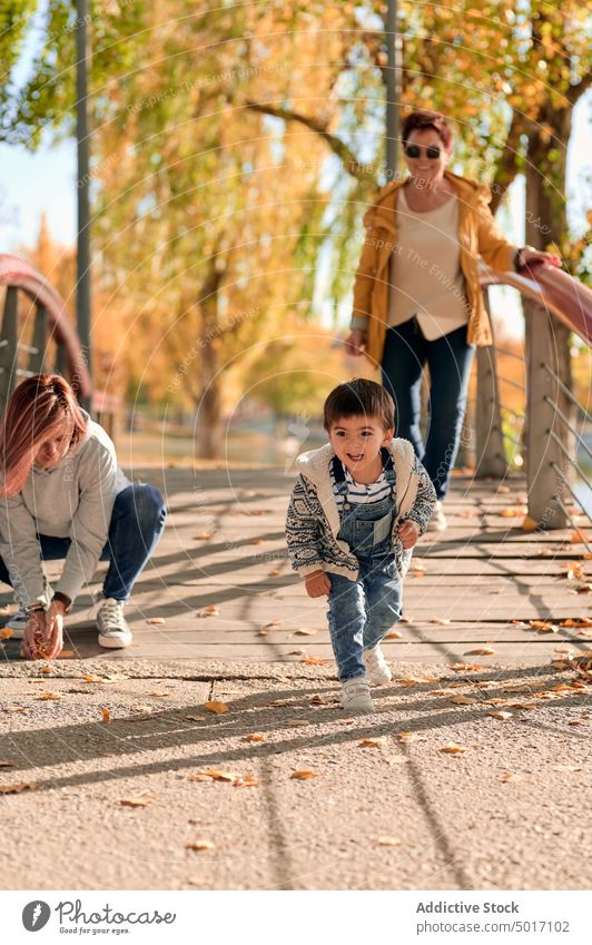 Happy LGBT family having fun in park lesbian couple child play autumn together happy love relationship kid cute cheerful mother women same sex lgbt lgbtq boy