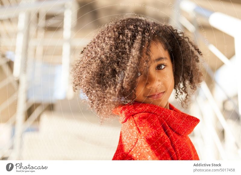 Smiling cute black girl on street sunshine smiling cheerful child step sunny day african american happy positive walk city town hairdo hairstyle female kid