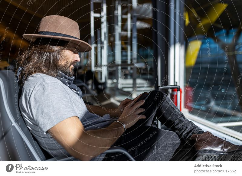 Man on a mobile phone at airport bench while waiting for a flight man transport smartphone travel terminal sleep using rest transportation flying passenger nap