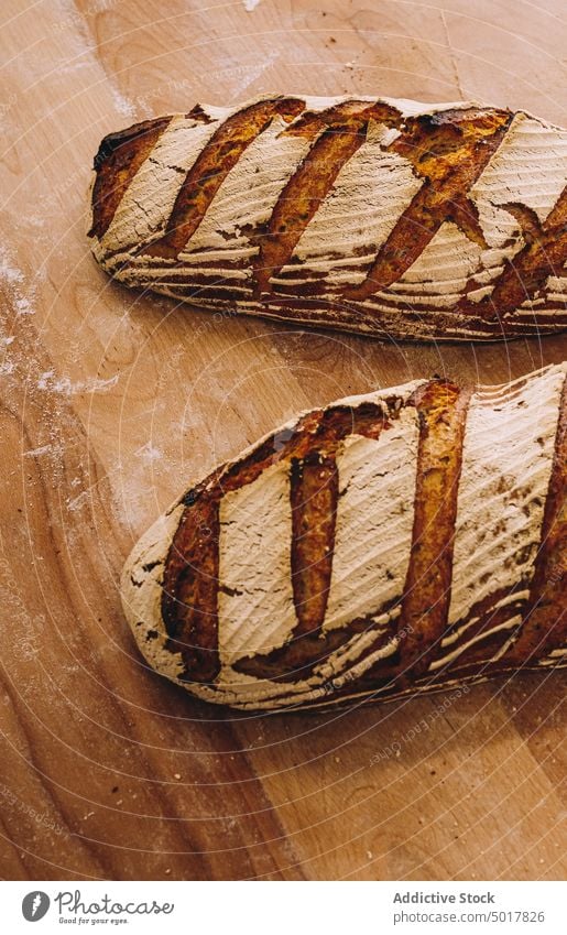 baked loaves of bread on wooden table bakery cook bakehouse production process industrial food prepare fresh kitchen pastry tradition loaf delicious