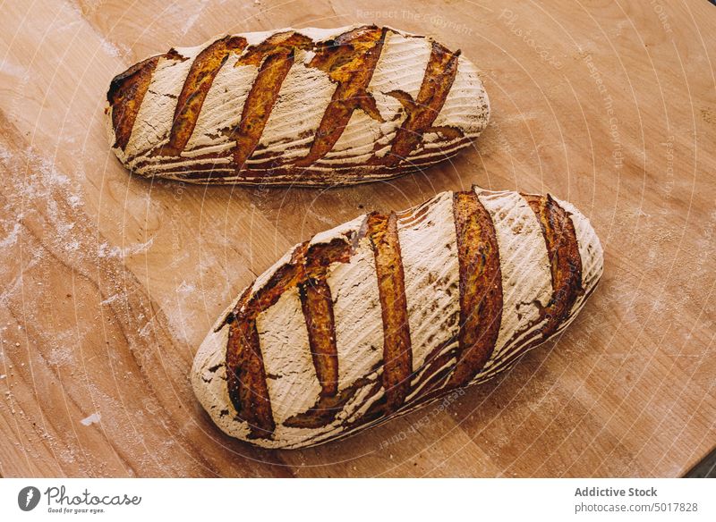 baked loaves of bread on wooden table bakery cook bakehouse production process industrial food prepare fresh kitchen pastry tradition loaf delicious