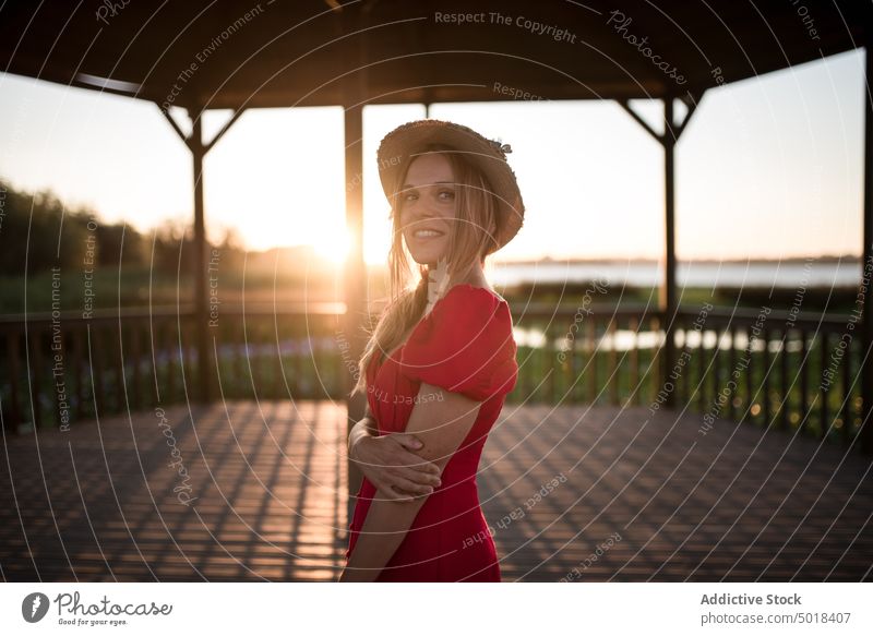 Woman admiring nature from veranda in evening traveler contemplate lagoon vacation trip terrace sky woman city feminine shadow admire landscape idyllic tourism