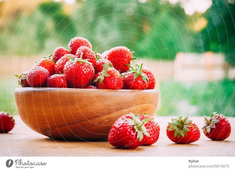 Wooden Bowl Filled With Fresh Ripe Red Strawberries On Wooden Table nature beautiful natural wooden tasty fresh agriculture red summer picnic garden bowl