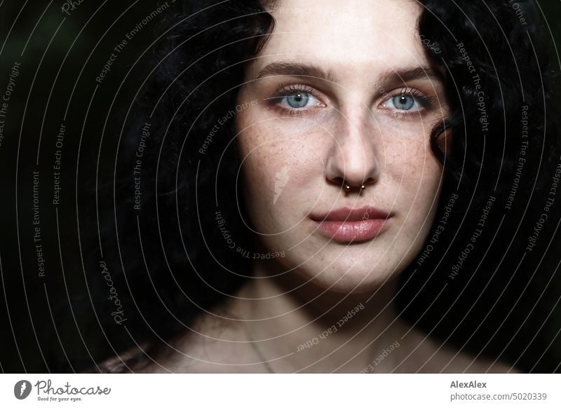 Close portrait of young dark haired woman with curls, light blue eyes and freckles Woman Young woman Freckles Curl Brunette long hairs pale pretty Skin Face