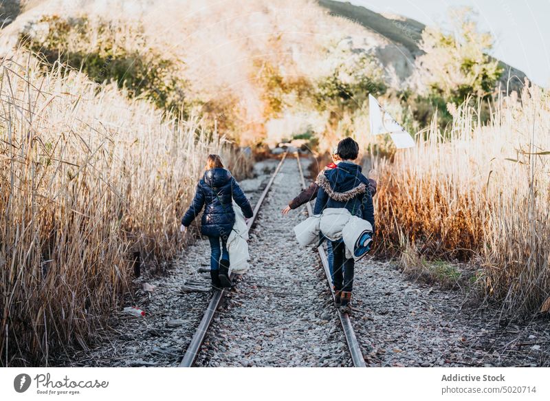 Anonymous of children hiking in the woods kids walking siblings discovery camping young friends group of kids excited three activity log family caucasian