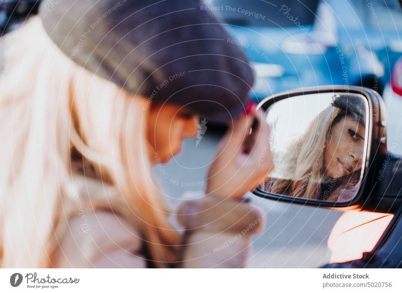 Ethnic female applying makeup near car woman wing mirror mascara african american young city street reflection ethnicity black vehicle modern contemporary style