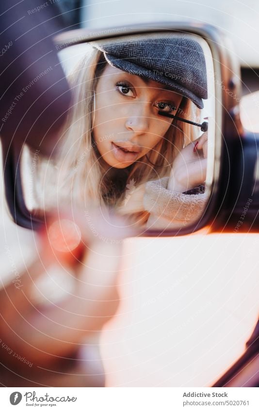 Ethnic female applying makeup near car woman wing mirror mascara african american young city street reflection ethnicity black vehicle modern contemporary style