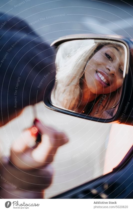 Ethnic female applying makeup near car woman wing mirror mascara african american young city street reflection ethnicity black vehicle modern contemporary style