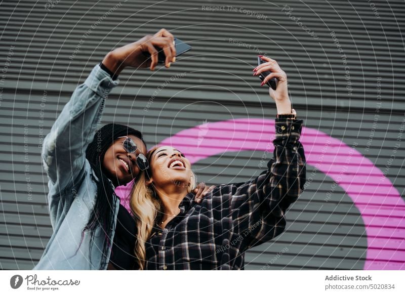 Black friends taking a self portrait on the street woman smartphones using city women together black urban modern mobile lifestyle leisure african american