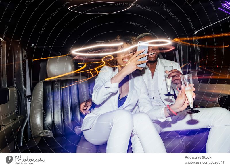 African American couple taking selfie in limousine party nightlife smartphone champagne fancy together ethnic ride man woman african american black gadget