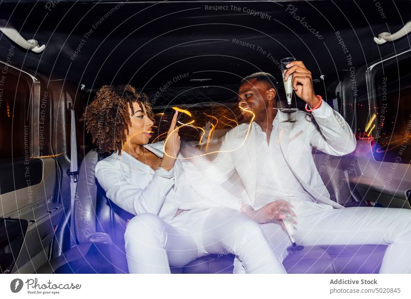 African American couple taking selfie in limousine party nightlife smartphone champagne fancy together ethnic ride man woman african american black gadget