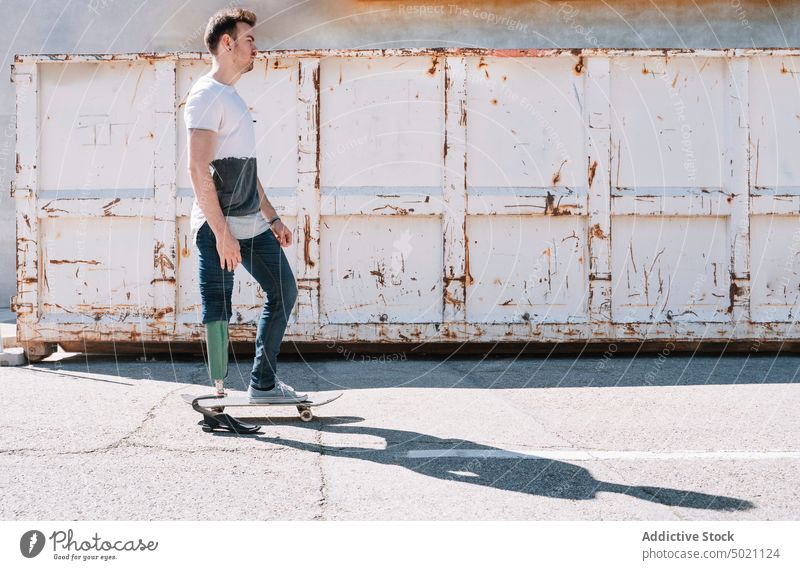 Man with artificial leg riding skateboard man ride determination motivation dynamic wall street amputee city exterior young concrete energy urban male