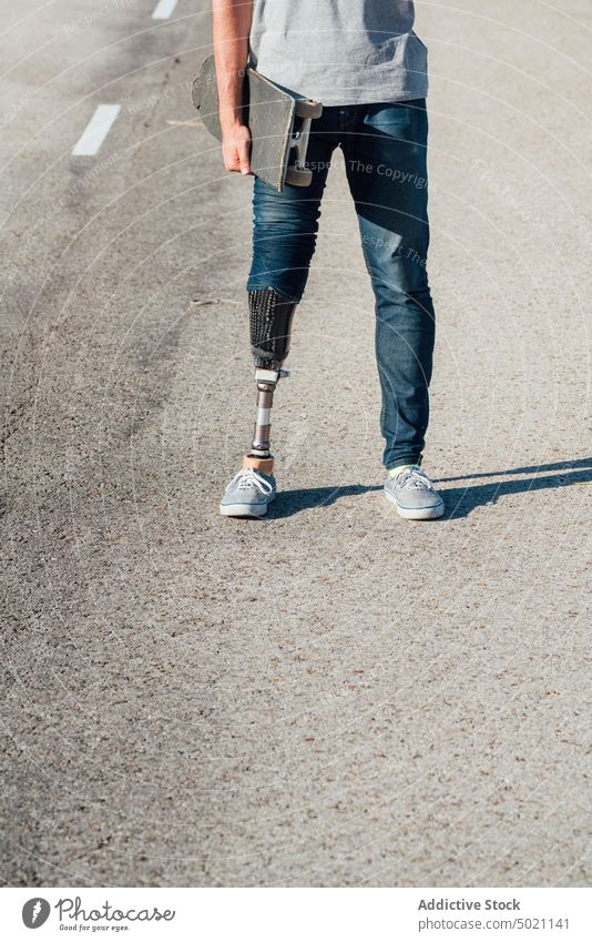 Anonymous Young Skater With Artificial Leg On Street street skateboard man urban young city outdoors amputee anonymous artificial break browsing casual crop