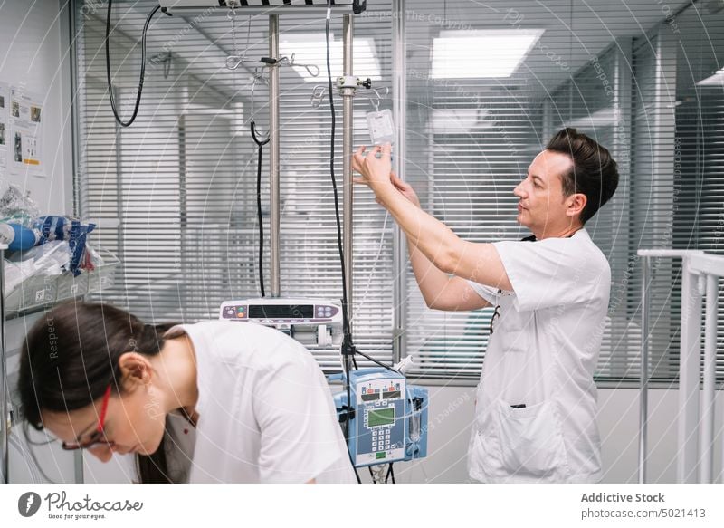 Pediatricians preparing the bed in the hospital for a newborn pediatrician procedure ward treatment examining device medical intensive care artificial equipment