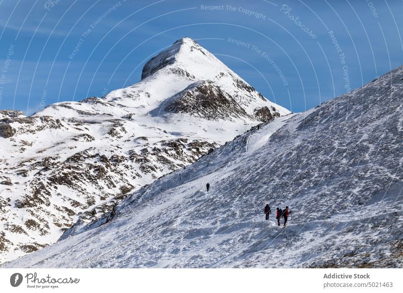 Travelers with trekking poles exploring snowy mountains traveler hike rough rock nature adventure explorer mountaineer climb stick range ridge pyrenees rocky