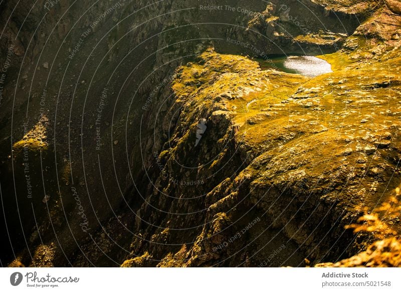 Mountain lake with mirrored surface mountain rock reflection landscape nature highland wild rough water range scenery ridge majestic magnificent rocky yellow