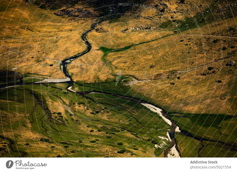 Creek flowing through mountainous terrain creek stream river slope nature landscape rocky highland environment scenic narrow range wild ridge scenery formation