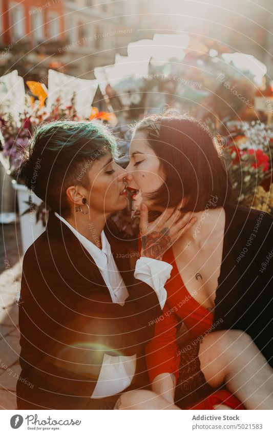 Young stylish ladies kissing on street lesbian couple piercing tattoo love young romantic relationship female adult girlfriend closed eyes lifestyle lovers