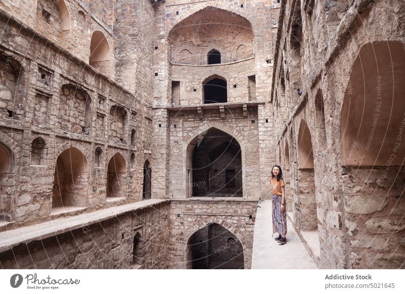 Ethnic tourist in historical step well woman old monument visit ethnic stone agrasen ki baoli new delhi india female asian building architecture oriental