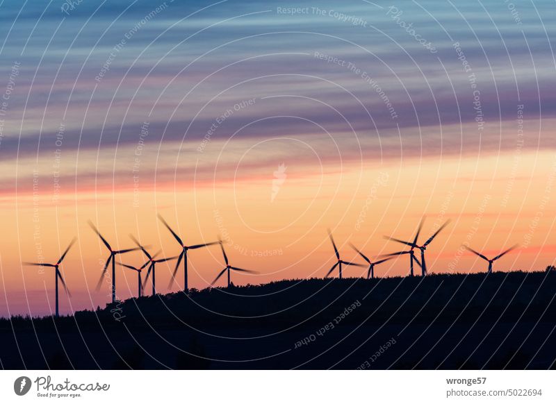 Wind turbines on the edge of an open-cast lignite mine sunset Wind energy plant Pinwheel open pit mining Cottbus North Lignite opencast lignite mining Twilight