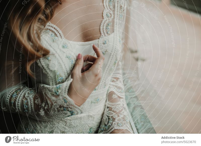 Young woman in dress near window bride hand gesture delicate lady wedding headband hair room darkness slim young white looking female passionate romantic