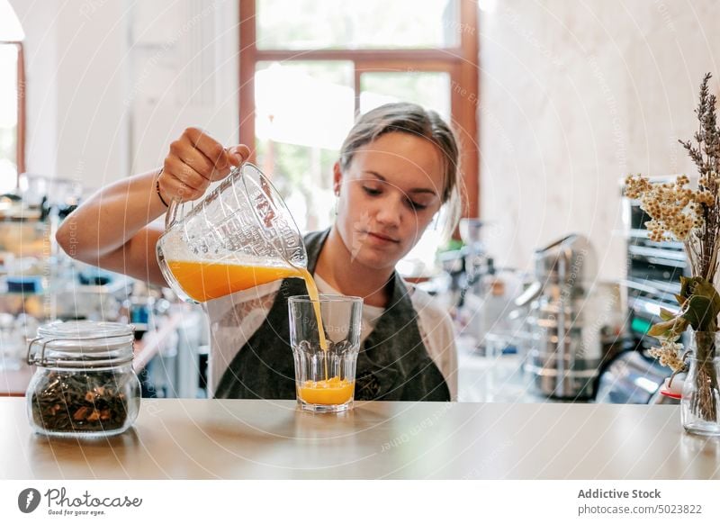 Bartender making fresh citrus juice at table woman bartender drink beverage fruit lemon healthy restaurant natural refreshment nutrition diet raw person cafe