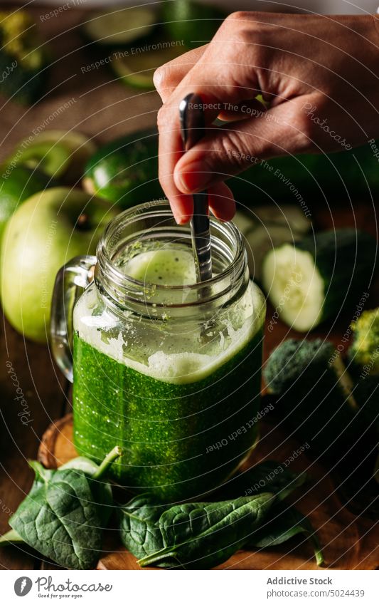 Anonymous person hand with delicious Veggie Smoothie photos apple avocado beverage blade broccoli citrus fruit color cooking cucumber desktop detox diet