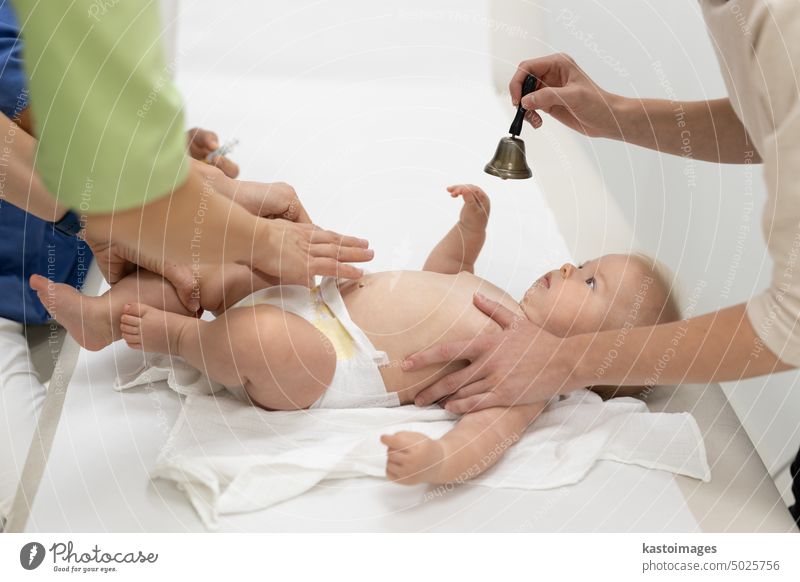 Baby beeing vaccinated by pediatrician in presence of his mother. Preventive vaccination against Diphtheria, whooping cough, tetanus, hepatitis, haemophilus influenzae, pneumococcus, poliomyelitis