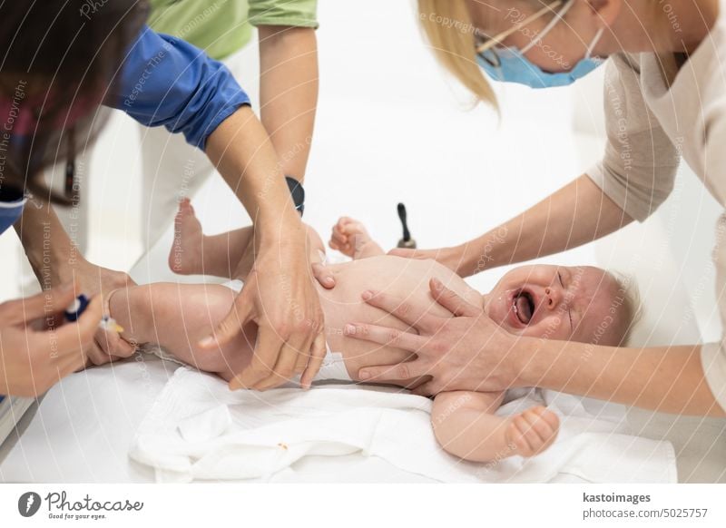 Baby beeing vaccinated by pediatrician in presence of his mother. Preventive vaccination against Diphtheria, whooping cough, tetanus, hepatitis, haemophilus influenzae, pneumococcus, poliomyelitis