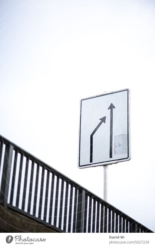 Two arrows on a sign - from left to right Arrow Orientation Sign Direction Lane change Trend-setting direction arrow Road sign Traffic infrastructure upstairs