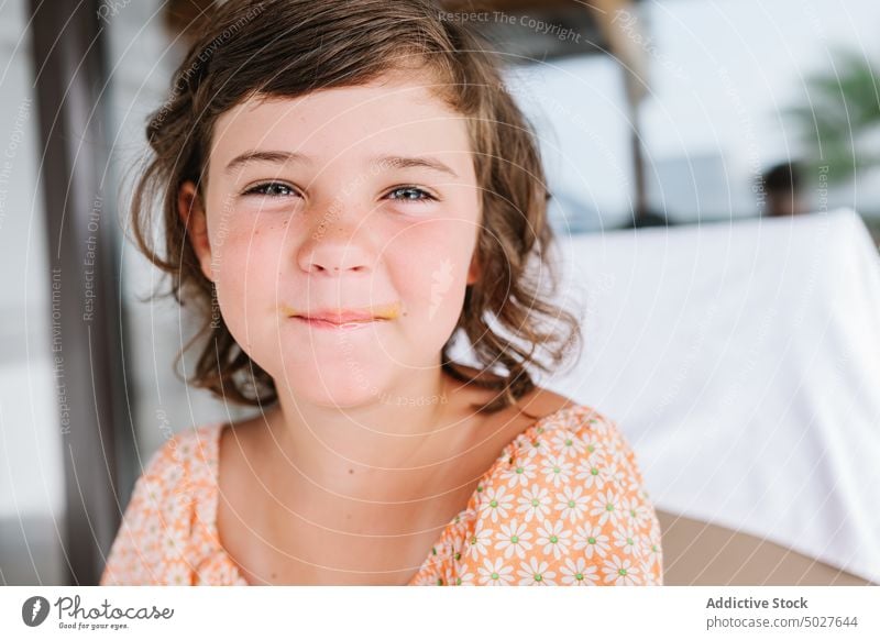 Satisfied preschool girl in cafeteria child kid childhood content innocent portrait leisure sweet cute brown hair pleasure green eyes dark hair brunette