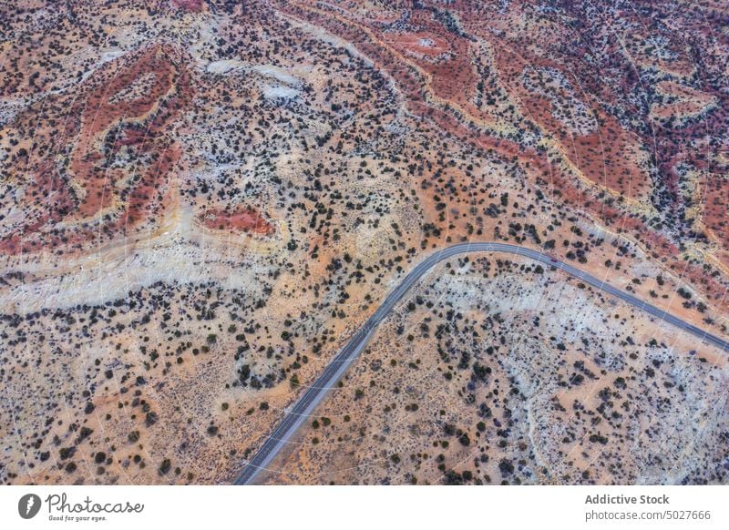 Drone view of asphalt road going through sandy valley in Utah highway mountain landscape Scenic Byway 12 roadway scenery route nature highland picturesque