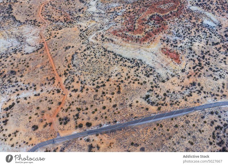 Drone view of asphalt road going through sandy valley in Utah highway mountain landscape Scenic Byway 12 roadway scenery route nature highland picturesque