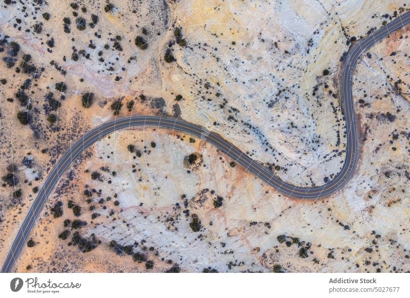 Drone view of asphalt road going through sandy valley in Utah highway mountain landscape Scenic Byway 12 roadway scenery route nature highland picturesque