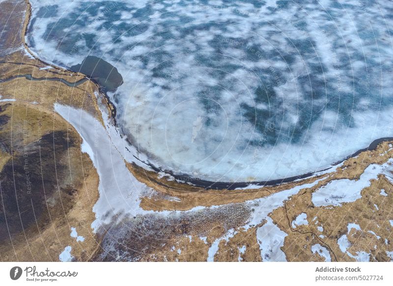 Frozen lake in mountains in winter ice glacier frozen nature north background geology slope cold environment weather rough season scenic snow arctic abstract