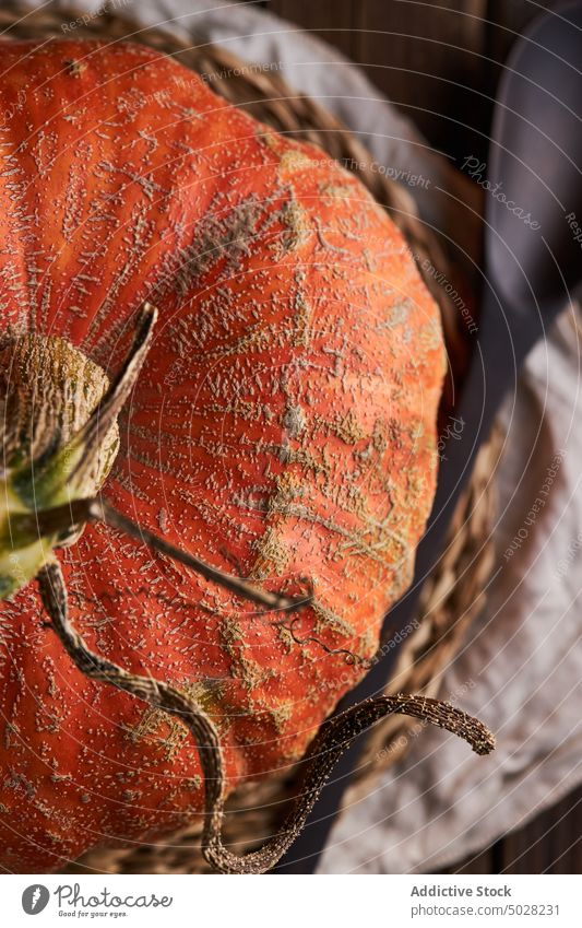 Whole pumpkin on wooden table fruit squash gourd farm ripe food spoon harvest agriculture uncooked halloween placemat edible vitamin whole autumn raw rustic