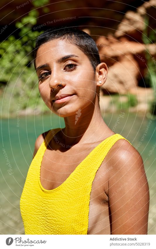 Hispanic female traveler near lake woman summer weekend nature daytime portrait water vacation hispanic ethnic young brunette pond appearance season short hair