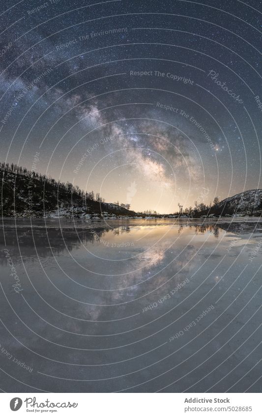 Scenic view of snowy mountains and lake under starry sky at night milky way light astronomy winter ridge reflection scenery shore river majestic highland